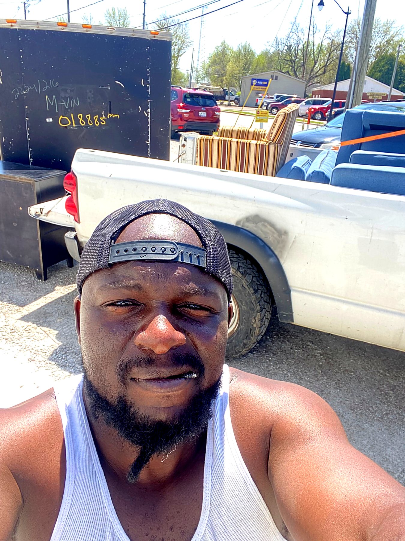 Owner with a pickup truck loaded with old furniture on a haul-off run