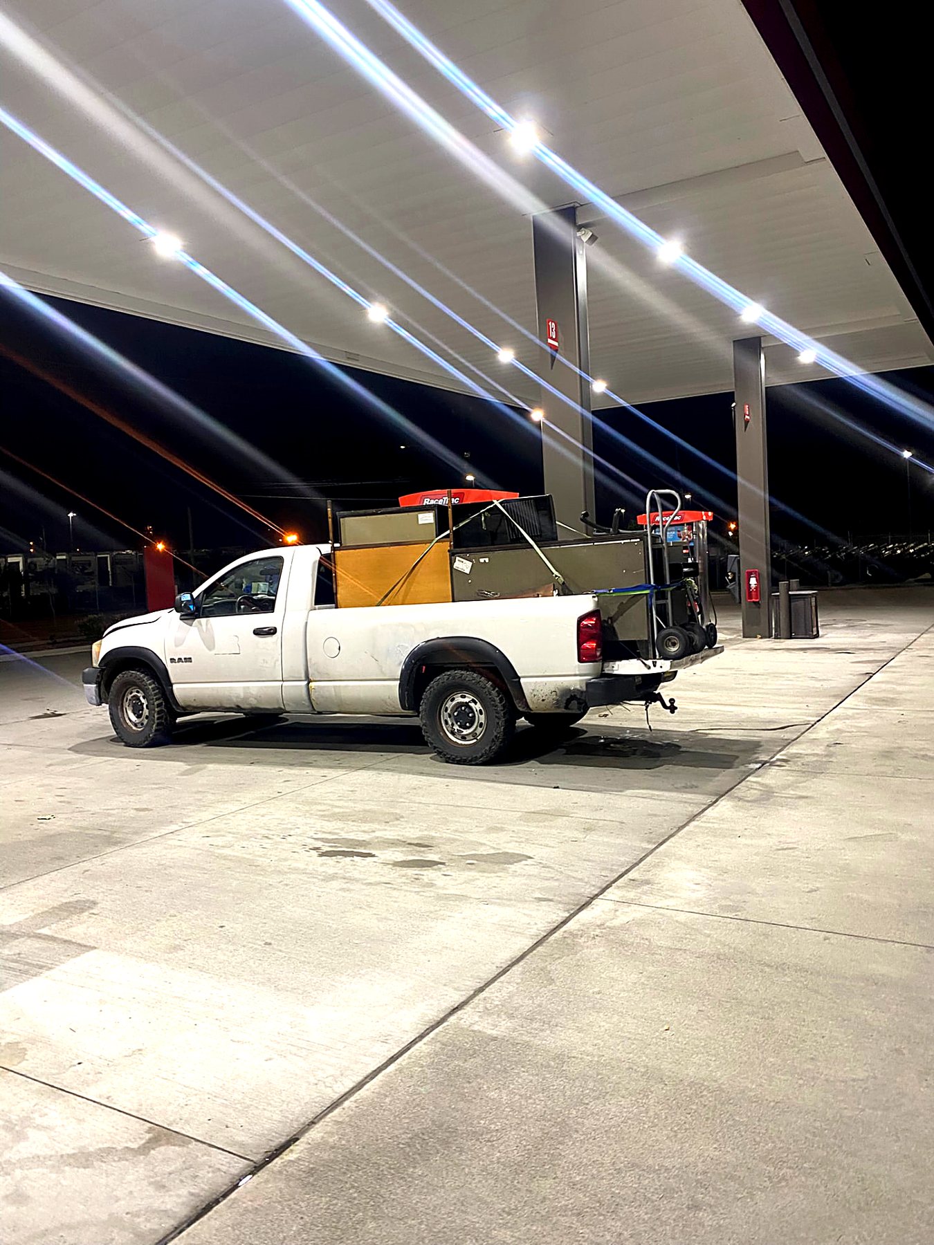 Pickup truck loaded with cabinets and a hand truck during an evening haul