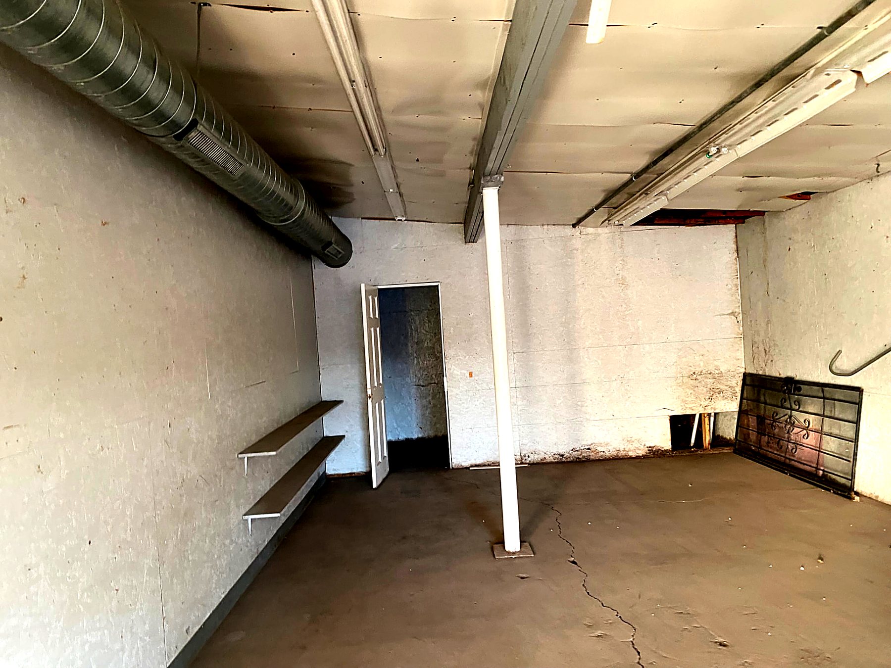The same lower level emptied and swept clean after debris removal