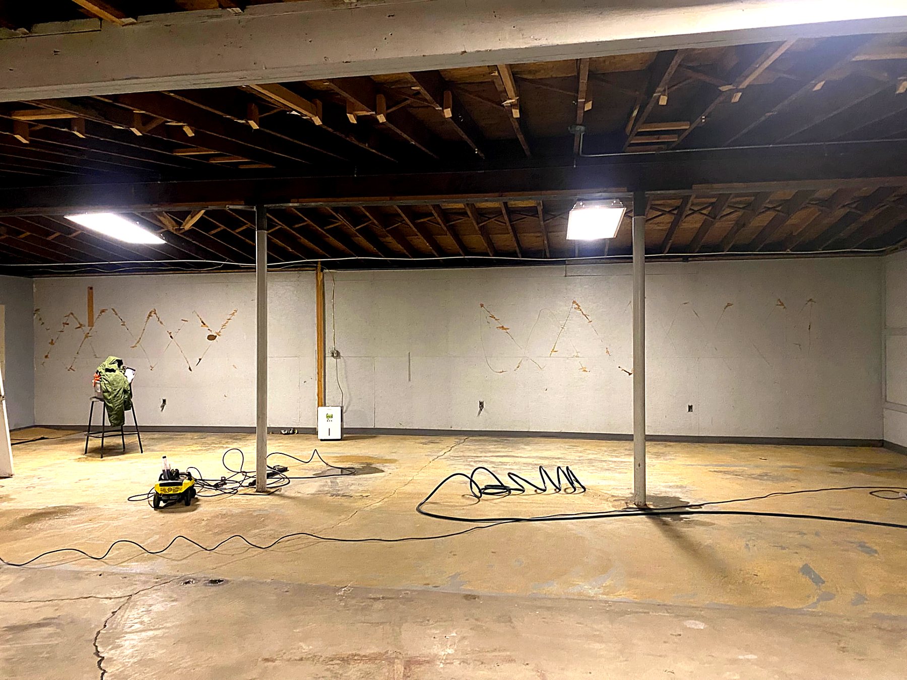 The same basement fully cleared with a clean concrete floor after cleanout