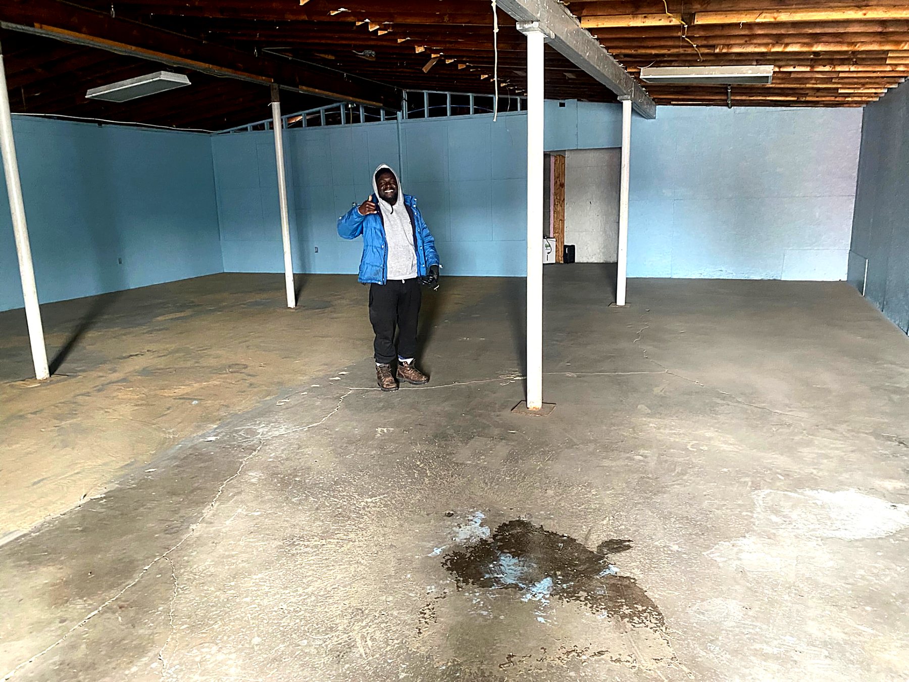 Indy Property Reset crew member in a cleared, swept basement after a full cleanout