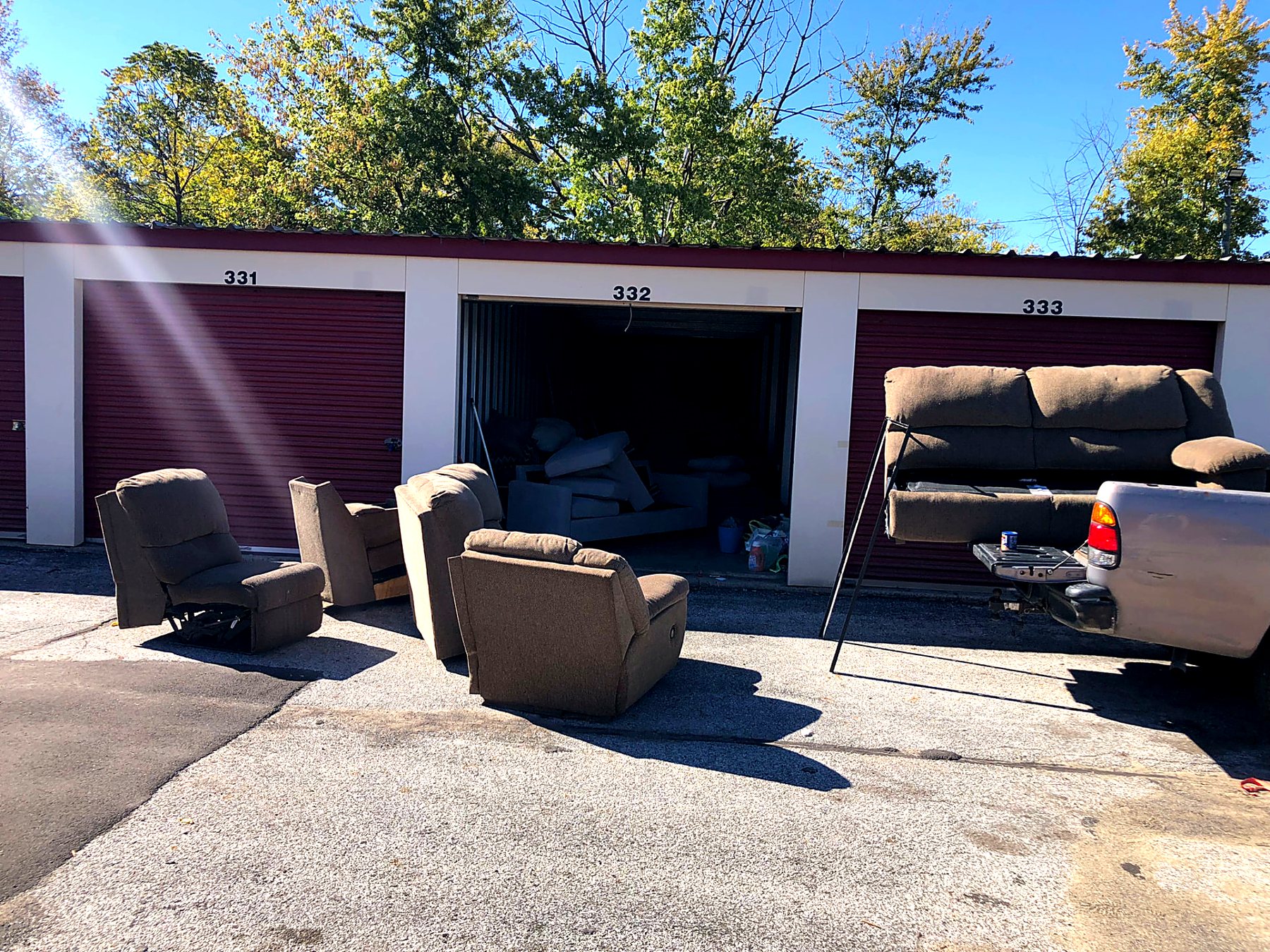 Recliners and couches pulled out of a storage unit for junk removal